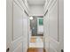 Hallway with closet featuring smooth sliding doors leading to the bathroom at 797 Ashland Ne Ave, Atlanta, GA 30307