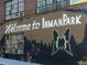 Mural with 'Welcome to Inman Park' lettering and butterfly artwork on a brick building at 797 Ashland Ne Ave, Atlanta, GA 30307