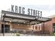 Exterior shot of Krog Street Market, showcasing its industrial design with outdoor seating and signage at 797 Ashland Ne Ave, Atlanta, GA 30307