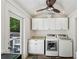Bright laundry room features white cabinets, granite countertops, and modern washer and dryer at 797 Ashland Ne Ave, Atlanta, GA 30307