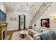 Bright living room with fireplace, adjacent staircase, and comfortable seating area with decorative pillows at 797 Ashland Ne Ave, Atlanta, GA 30307