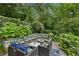 A relaxing outdoor seating area with custom seating arranged around a fire pit and lush green backdrop at 797 Ashland Ne Ave, Atlanta, GA 30307