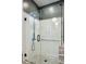 Elegant shower with glass door, subway tile walls, and penny tile floor with updated fixtures at 797 Ashland Ne Ave, Atlanta, GA 30307