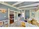 Bright sunroom featuring a comfortable yellow couch, stylish furnishings, and an inviting atmosphere at 797 Ashland Ne Ave, Atlanta, GA 30307