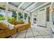 Relaxing sunroom with a cozy yellow couch, bright natural light, and a stylish white patterned rug at 797 Ashland Ne Ave, Atlanta, GA 30307