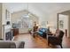 Bright living room with a fireplace, hardwood floors, and a vaulted ceiling at 2565 Grapevine Cir # 103, Cumming, GA 30041