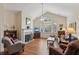 Cozy living room features a fireplace, vaulted ceiling, and plenty of natural light at 2565 Grapevine Cir # 103, Cumming, GA 30041