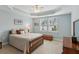 Spacious main bedroom featuring tray ceiling, ceiling fan, and natural light from large windows at 2565 Grapevine Cir # 103, Cumming, GA 30041