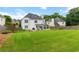 Spacious backyard with lush lawn, mature trees, and fenced perimeter at 290 Bluff Oak Dr, Roswell, GA 30076