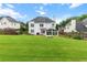 Expansive green backyard with a patio, sunroom addition and manicured lawn at 290 Bluff Oak Dr, Roswell, GA 30076