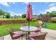 Landscaped backyard featuring a patio set, privacy fence, and play equipment at 290 Bluff Oak Dr, Roswell, GA 30076