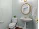 Neat powder room features modern sink with gold hardware and new paint at 290 Bluff Oak Dr, Roswell, GA 30076