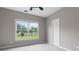 Neutral bedroom with a large window overlooking the backyard at 290 Bluff Oak Dr, Roswell, GA 30076