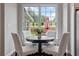 Cozy breakfast nook with a view of the lush backyard and ample natural light at 290 Bluff Oak Dr, Roswell, GA 30076