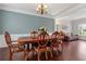 Elegant dining room with hardwood floors, wainscoting, and a decorative chandelier at 290 Bluff Oak Dr, Roswell, GA 30076