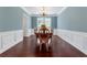 Light dining room with hardwood floors, wainscoting and crown molding at 290 Bluff Oak Dr, Roswell, GA 30076