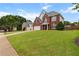 Beautiful two-story home with a lush green lawn and mature trees, perfect for families at 290 Bluff Oak Dr, Roswell, GA 30076