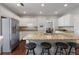 Spacious kitchen featuring granite countertops, stainless steel appliances, and a breakfast bar at 290 Bluff Oak Dr, Roswell, GA 30076