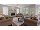 Bright living room with fireplace, ceiling fan, hardwood floors and large windows with outside view at 290 Bluff Oak Dr, Roswell, GA 30076