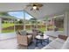 Bright sunroom with wicker furniture and a view of the backyard at 290 Bluff Oak Dr, Roswell, GA 30076