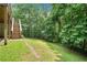 Manicured backyard with stairs and a wooded view at 308 Golden Ct, Canton, GA 30114