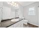 Bathroom with vanity, window, shower, and toilet at 308 Golden Ct, Canton, GA 30114