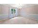 Elegant dining room featuring crown molding, wainscoting and a stylish chandelier at 308 Golden Ct, Canton, GA 30114