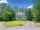 Charming two-story traditional home featuring a welcoming front porch and well-manicured lawn at 308 Golden Ct, Canton, GA 30114