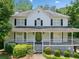 Beautiful white home featuring a classic design and covered porch at 308 Golden Ct, Canton, GA 30114