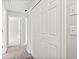 Hallway with carpet and white closet doors with knobs at 308 Golden Ct, Canton, GA 30114