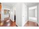 Hallway with hardwood floors and doorways leading to various rooms at 308 Golden Ct, Canton, GA 30114
