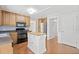 Bright kitchen with wood cabinets, a central island, and modern appliances at 308 Golden Ct, Canton, GA 30114