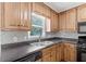 Kitchen with stainless steel sink, black appliances, and patterned backsplash at 308 Golden Ct, Canton, GA 30114