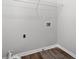 Laundry room with wood floors, wire shelf, and connections at 308 Golden Ct, Canton, GA 30114