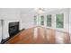 Sunlit living room featuring a fireplace, hardwood floors and multiple windows at 308 Golden Ct, Canton, GA 30114