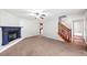 Living room with fireplace, ceiling fan, carpet and staircase access at 308 Golden Ct, Canton, GA 30114
