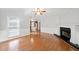 Spacious living room with hardwood floors, a fireplace, and views of the kitchen at 308 Golden Ct, Canton, GA 30114