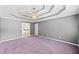 Main bedroom featuring tray ceiling and attached bath at 308 Golden Ct, Canton, GA 30114