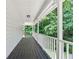 Expansive covered porch with wood flooring and views of mature trees at 308 Golden Ct, Canton, GA 30114