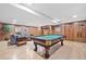 Finished basement with a pool table, wood paneling, and a cozy seating area at 335 S Satinwood Pl, Roswell, GA 30076