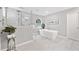 Bright bathroom with a soaking tub, glass-enclosed shower, and modern fixtures at 335 S Satinwood Pl, Roswell, GA 30076