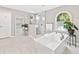 A luxurious bathroom features a freestanding tub, tiled shower, and a window with natural light at 335 S Satinwood Pl, Roswell, GA 30076