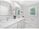 Modern bathroom featuring a double sink vanity, sleek mirrors, and ample natural light at 335 S Satinwood Pl, Roswell, GA 30076