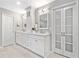 Bathroom boasts double sinks with white cabinets, modern fixtures, and sleek lighting at 335 S Satinwood Pl, Roswell, GA 30076