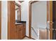 Traditional-style half bathroom features dark countertops and wood cabinets at 335 S Satinwood Pl, Roswell, GA 30076