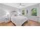 Charming bedroom features two windows, a bed with decorative headboard, and hardwood floors at 335 S Satinwood Pl, Roswell, GA 30076