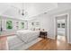 Bright bedroom showcasing a large bed, hardwood floors, and natural light from the large windows at 335 S Satinwood Pl, Roswell, GA 30076