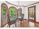 Breakfast nook featuring bay windows overlooking backyard and access to sunroom at 335 S Satinwood Pl, Roswell, GA 30076