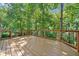 Expansive wooden deck offering serene views of the surrounding lush greenery at 335 S Satinwood Pl, Roswell, GA 30076