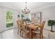 Bright, elegant dining room featuring a decorative chandelier and shuttered windows at 335 S Satinwood Pl, Roswell, GA 30076